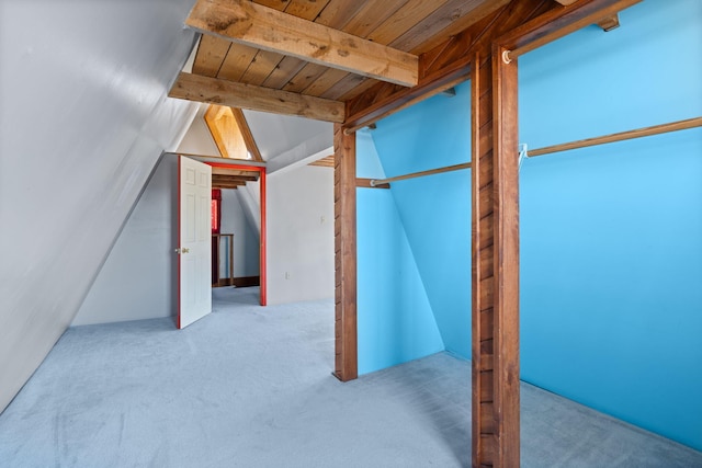 additional living space with lofted ceiling with beams, light colored carpet, and wooden ceiling