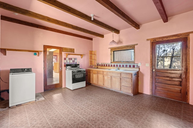 kitchen with light brown cabinetry, sink, pendant lighting, washer / clothes dryer, and white gas range oven