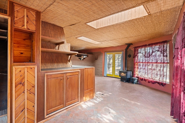 kitchen featuring a skylight and a wood stove