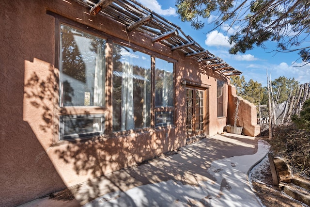 view of home's exterior featuring a pergola and a patio area