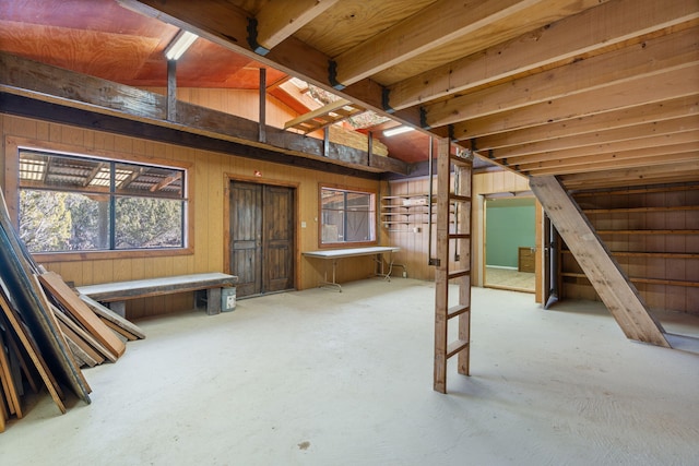 basement featuring wooden walls