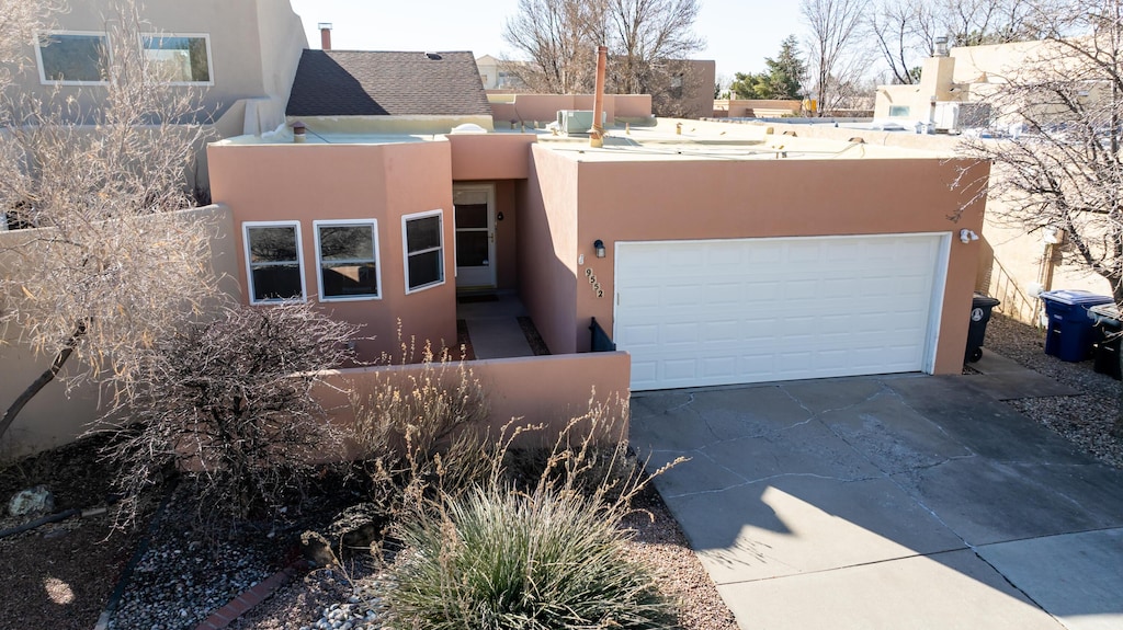 pueblo-style home with a garage