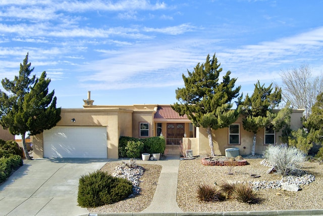 pueblo-style house with a garage