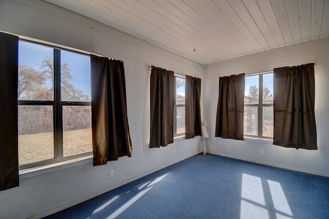 unfurnished room with wooden ceiling