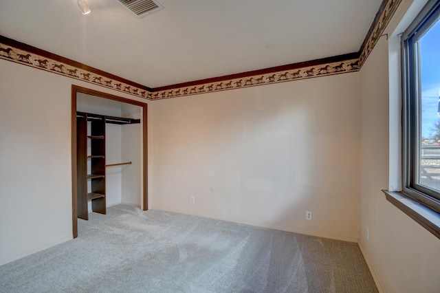 unfurnished bedroom featuring light colored carpet and ornamental molding