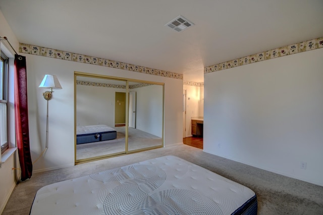 carpeted bedroom featuring a closet