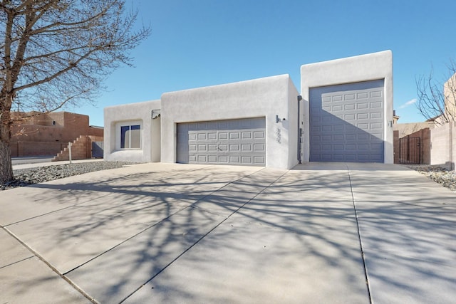 pueblo-style home with a garage