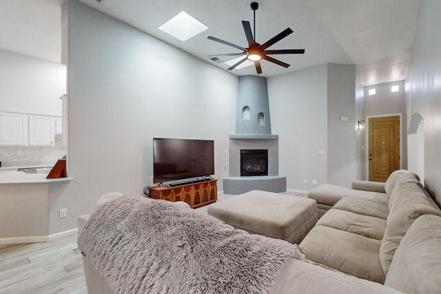 living room with light hardwood / wood-style flooring and ceiling fan