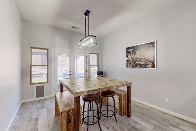 dining room featuring light hardwood / wood-style flooring and french doors