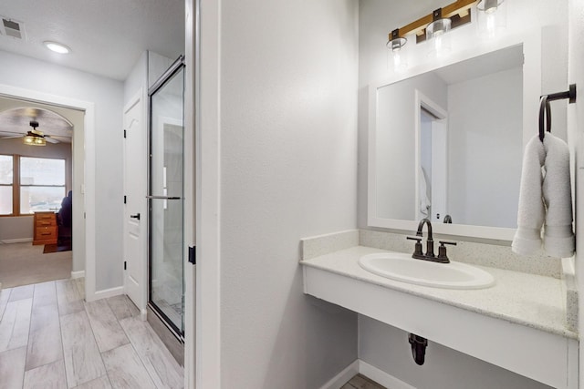 bathroom with wood-type flooring, sink, and ceiling fan