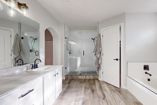 bathroom with vanity, hardwood / wood-style flooring, and separate shower and tub