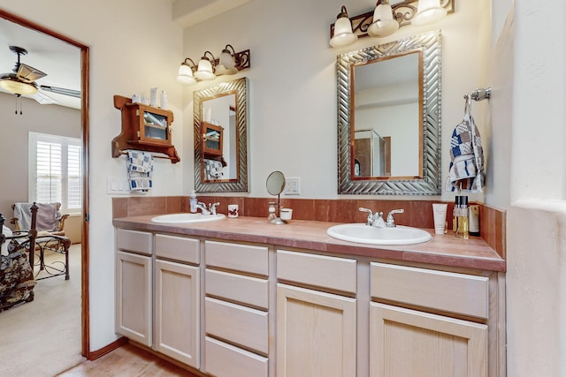 bathroom with ceiling fan and vanity