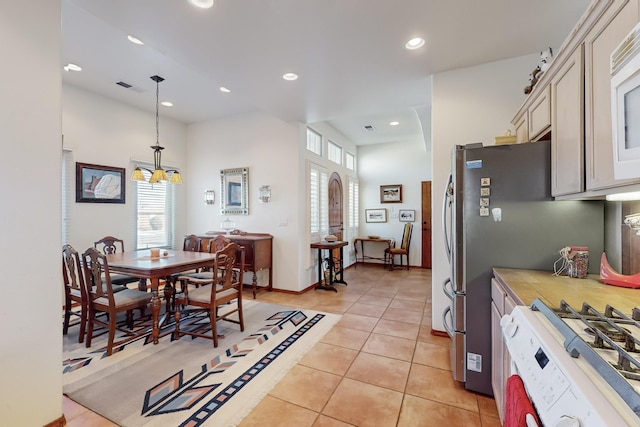 tiled dining space featuring a chandelier