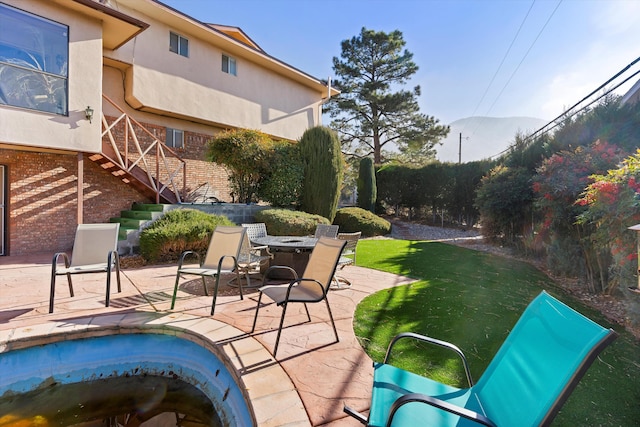 view of pool with a mountain view, a yard, and a patio