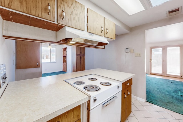 kitchen with light carpet and white range with electric stovetop