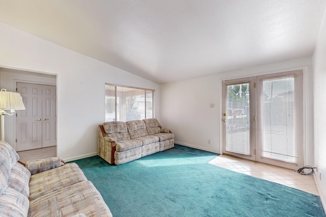 living room featuring a healthy amount of sunlight, light colored carpet, and lofted ceiling