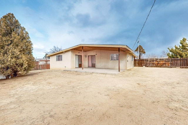 rear view of property featuring a patio