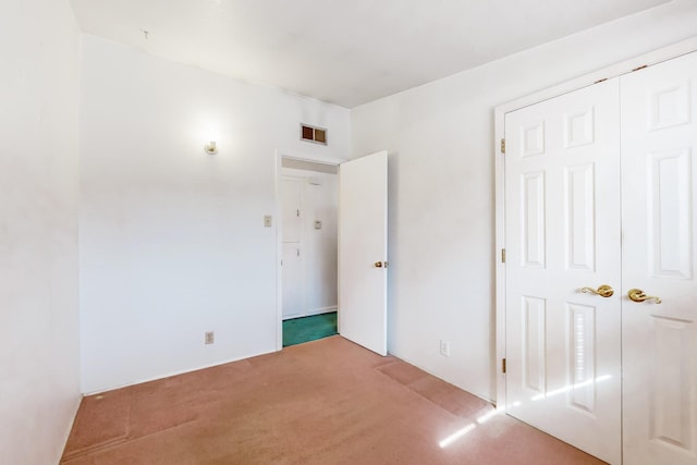 unfurnished bedroom featuring a closet and carpet