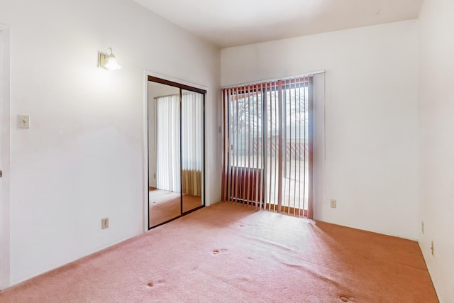 unfurnished bedroom with carpet floors and a closet