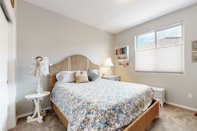 bedroom featuring light carpet