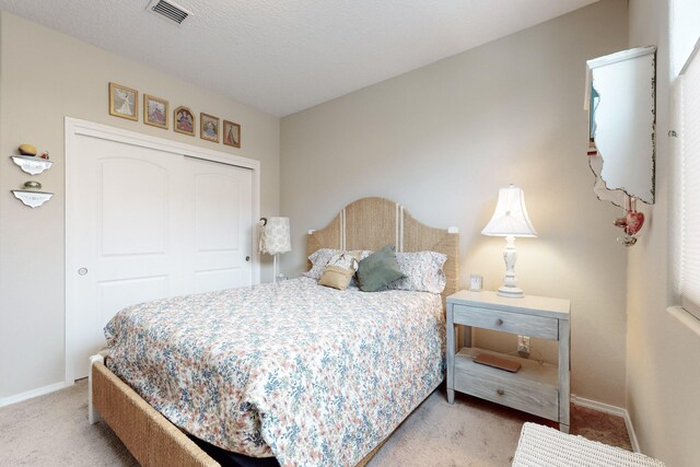 carpeted bedroom with a closet