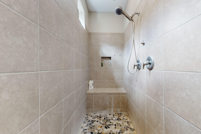 bathroom with a tile shower