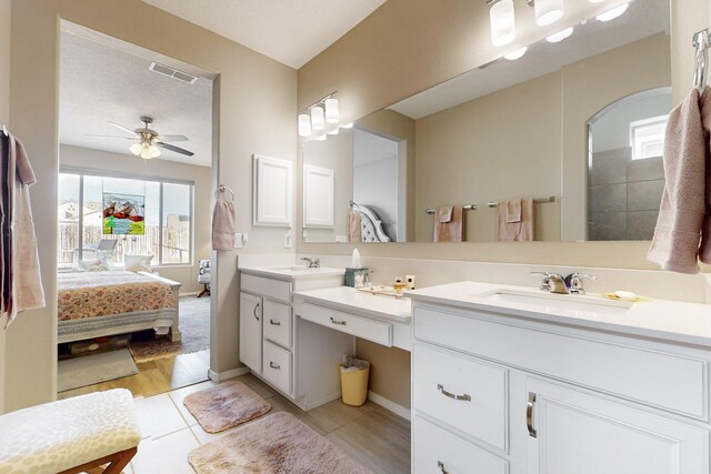 bathroom featuring ceiling fan, vanity, and tile patterned floors