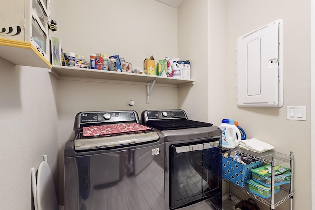 clothes washing area featuring electric panel and independent washer and dryer