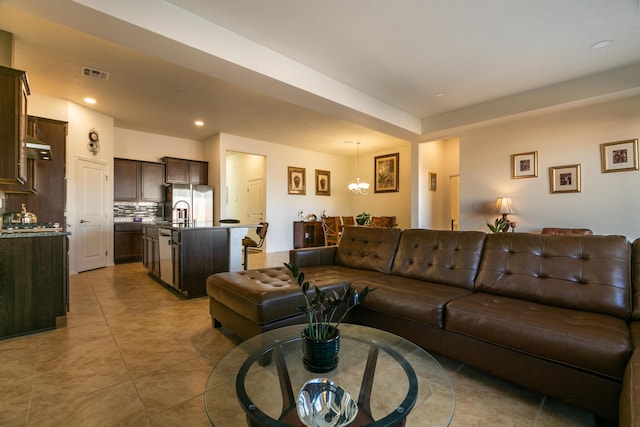 living area featuring an inviting chandelier, light tile patterned floors, visible vents, and recessed lighting