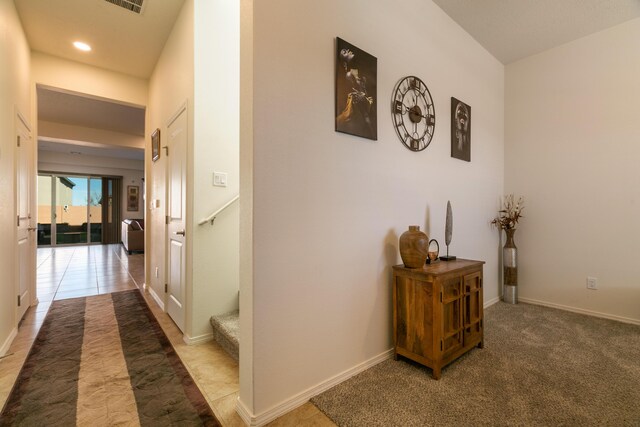 dining space with light tile patterned floors, a raised ceiling, a tile fireplace, and baseboards