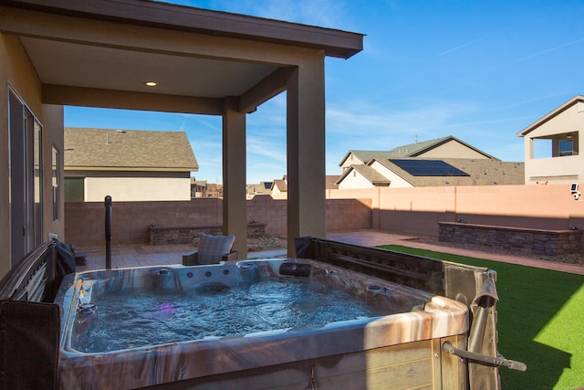 view of pool with a hot tub and a fenced backyard