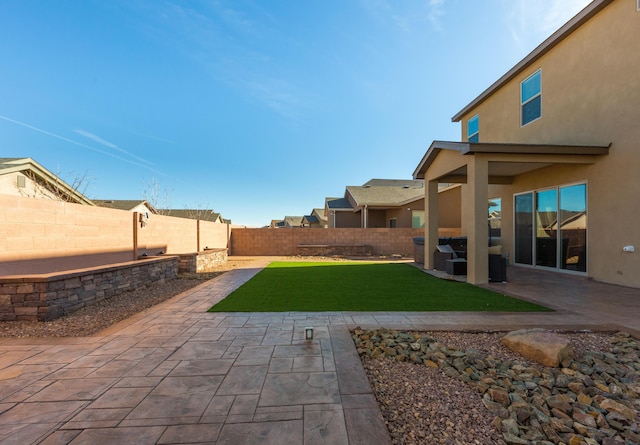 view of yard with a patio area and a fenced backyard