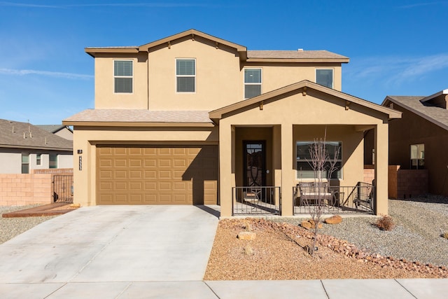 traditional-style house featuring a porch, an attached garage, fence, driveway, and stucco siding