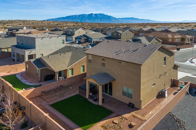 birds eye view of property with a residential view and a mountain view