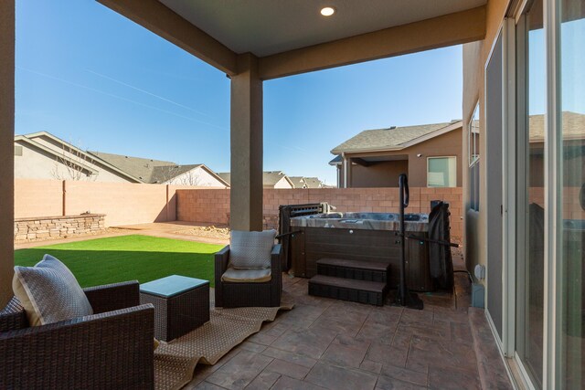 view of patio / terrace featuring a fenced backyard and a hot tub