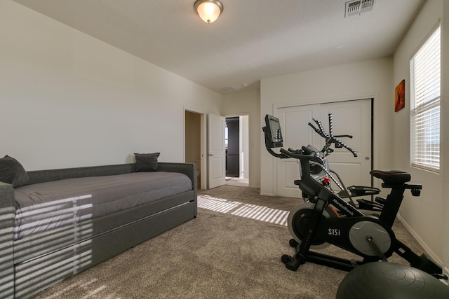 exercise area with carpet, visible vents, and baseboards