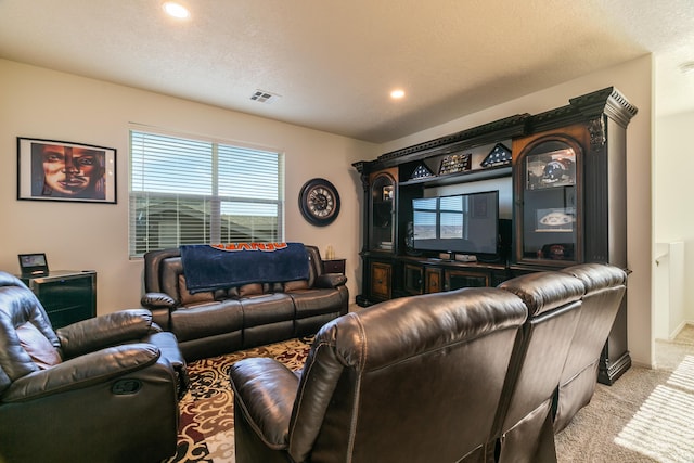 carpeted living room with a textured ceiling, visible vents, and recessed lighting