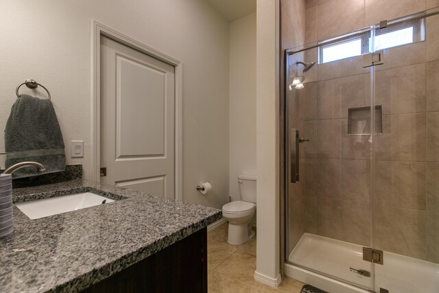 full bath with toilet, a shower stall, tile patterned flooring, and vanity