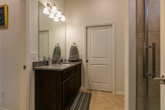 bathroom with tile patterned flooring, vanity, and baseboards