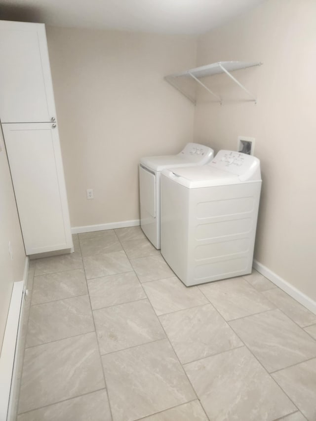 laundry area with cabinets and independent washer and dryer