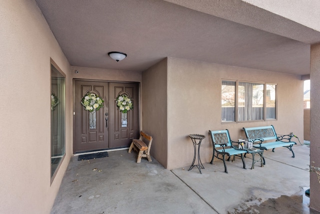 view of exterior entry featuring a porch