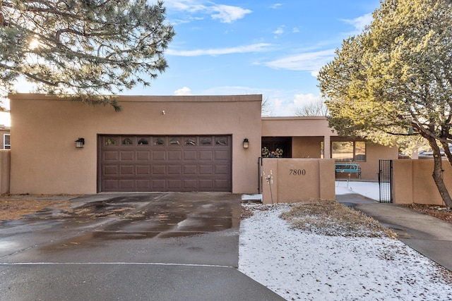 adobe home featuring a garage