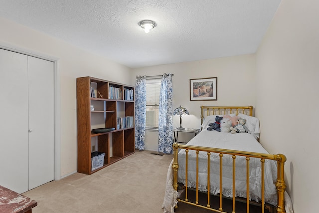 carpeted bedroom with a textured ceiling