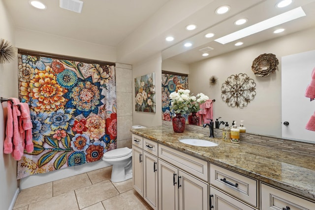 bathroom with tile patterned floors, vanity, and toilet