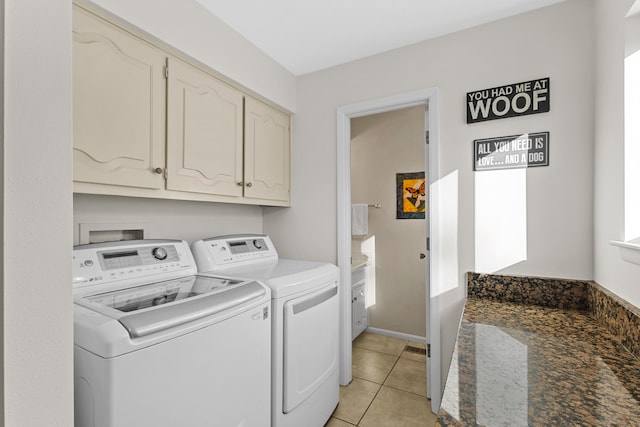 washroom with cabinets, separate washer and dryer, and light tile patterned floors