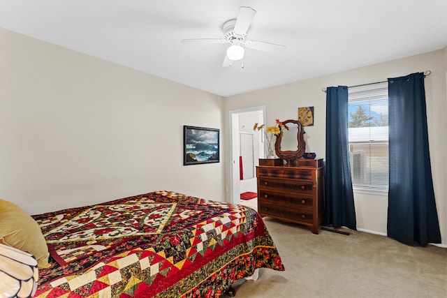 bedroom featuring light colored carpet and ceiling fan