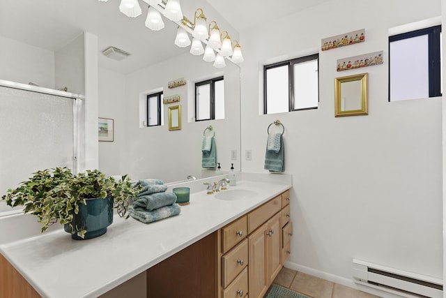 bathroom featuring vanity, a shower with shower door, tile patterned floors, and baseboard heating