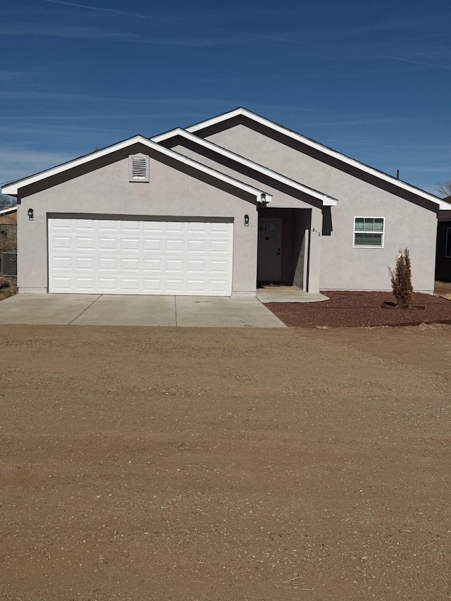 ranch-style home with a garage and cooling unit