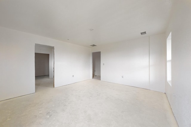 spare room featuring visible vents and concrete floors