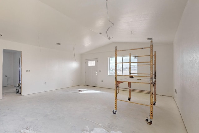 unfurnished room with lofted ceiling